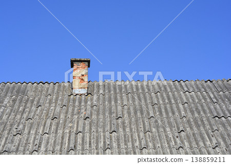 Old Brick Chimney on Asbestos Tile Roof 138859211
