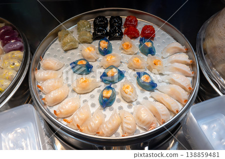 Colorful Assortment of Dim Sum in a Steamer Basket at a Vibrant Asian Night Food Market Colorful Assortment of Dim Sum in a Steamer Basket at a Vibrant Asian Night Food Market 138859481
