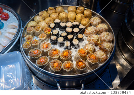 Colorful Array of Dim Sum and Sushi Delights at a Vibrant Asian Night Food Market in China Colorful Array of Dim Sum and Sushi Delights at a Vibrant Asian Night Food Market in China 138859484