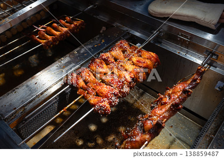 Grilled Skewers Glaze with Sauce at Vibrant Asian Night Food Street Market in China Grilled Skewers Glaze with Sauce at Vibrant Asian Night Food Street Market in China 138859487