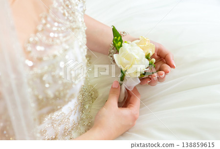 Bride's hands with a bouquet for the groom. place for text 138859615