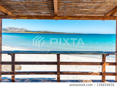 La Pelosa Beach view from a wooden veranda with Isola Piana in the background Sardinia La Pelosa Beach view from a wooden veranda with Isola Piana in the background Sardinia 138859838