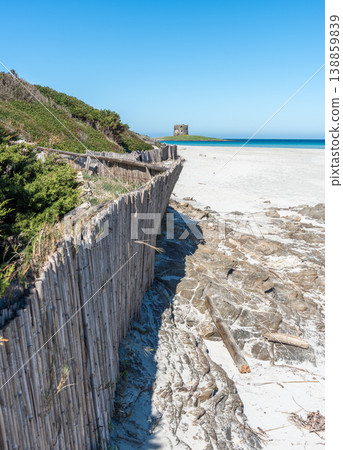 Vertical view of La Pelosa Beach with wooden fences and Aragonese tower in Sardinia Vertical view of La Pelosa Beach with wooden fences and Aragonese tower in Sardinia 138859839