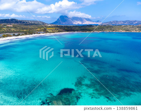 Aerial view of turquoise water shades at Lu Impostu beach with Tavolara island in background 138859861