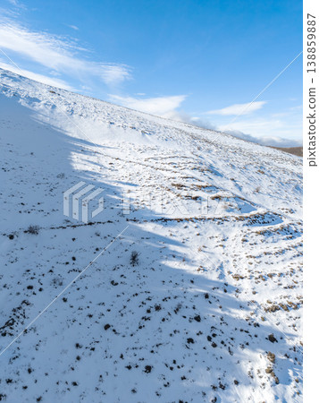 Snow Covered Hill in Winter Landscape under Clear Blue Sky Snow Covered Hill in Winter Landscape under Clear Blue Sky 138859887
