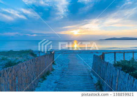 Beach Path at Sunset with Calm Sea and Sunlight Reflections Beach Path at Sunset with Calm Sea and Sunlight Reflections 138859921