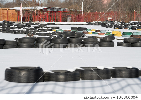 Old tires on a kart racing track . Racetrack fence Old tires on a kart racing track . Racetrack fence 138860004
