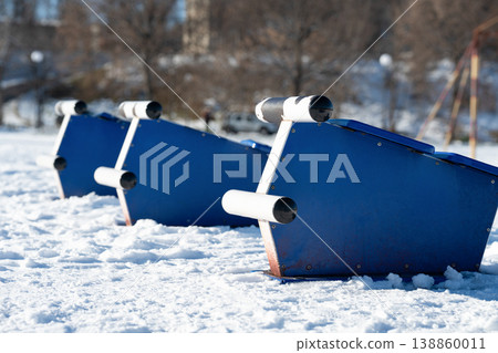 Outdoor gym equipment in a public park . Outdoor gym equipment in a public park . 138860011