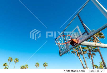 Basketball Hoop with Palm Trees Under Blue Sky in California 138860129