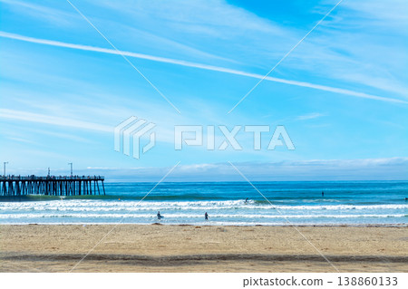 Surfers by Pismo Beach Pier on a sunny day 138860133