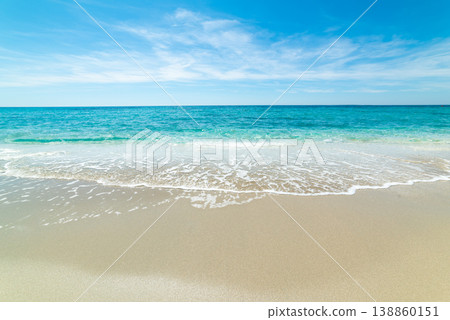 Beach with turquoise water and white sand under a blue sky in Sardinia Beach with turquoise water and white sand under a blue sky in Sardinia 138860151