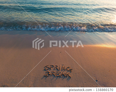 Horizontal view of Spring Break written on the sand at sunset Horizontal view of Spring Break written on the sand at sunset 138860170