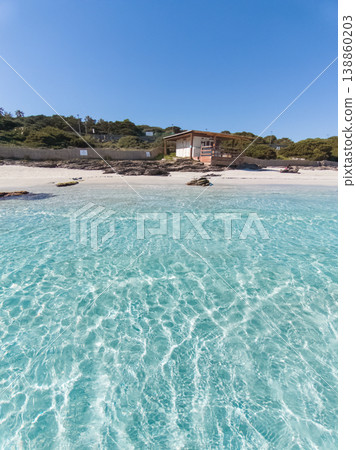Wooden hut by the sea seen from the water in Sardinia Wooden hut by the sea seen from the water in Sardinia 138860203