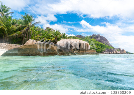 Tropical beach with granite rocks seen from the water Tropical beach with granite rocks seen from the water 138860209