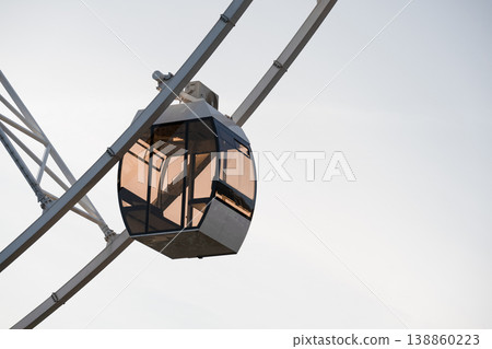Close up of a Ferris wheel cabin under the sky . Copy space Close up of a Ferris wheel cabin under the sky . Copy space 138860223