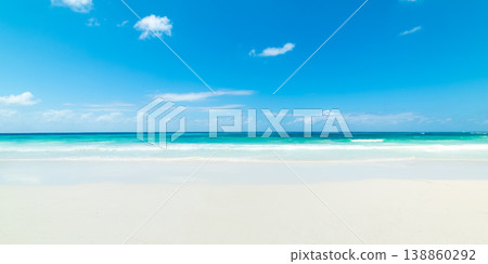 White sand beach with turquoise water under a blue sky with small clouds White sand beach with turquoise water under a blue sky with small clouds 138860292