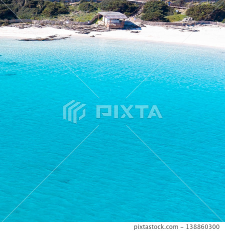Aerial view of a wooden hut by the sea seen from the water 138860300