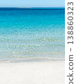 White sand beach with turquoise water under a clear sky. 138860323