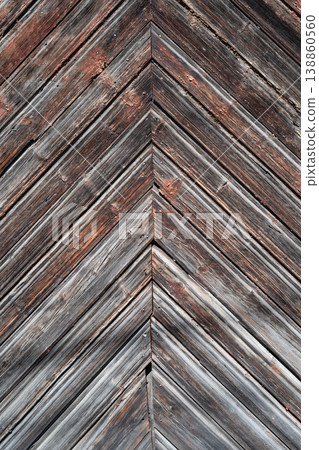 Rustic weathered wooden planks arranged in a chevron pattern with aged texture and peeling paint. Rustic weathered wooden planks arranged in a chevron pattern with aged texture and peeling paint. 138860560