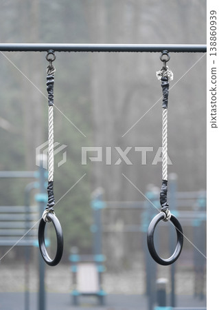 Gymnastic Rings with Straps for Exercise . Outdoor training . Outdoor training in bad weather Gymnastic Rings with Straps for Exercise . Outdoor training . Outdoor training in bad weather 138860939