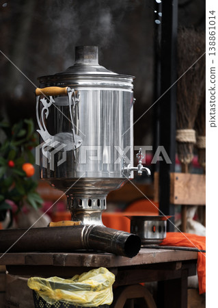 Traditional Russian samovar close up view . A smoking samovar on the table. The concept of a festive tea party 138861014