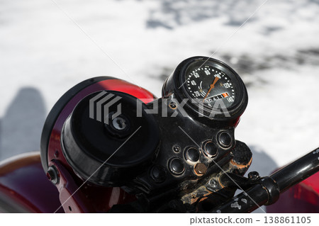 Closeup photo of a round black speedometer of an old retro motorcycle Closeup photo of a round black speedometer of an old retro motorcycle 138861105