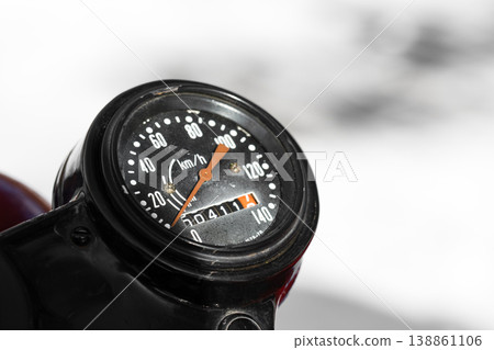 Closeup photo of a round black speedometer of an old Soviet motorcycle 138861106