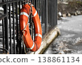 Orange lifebuoy close-up on a background of frozen lake 138861134