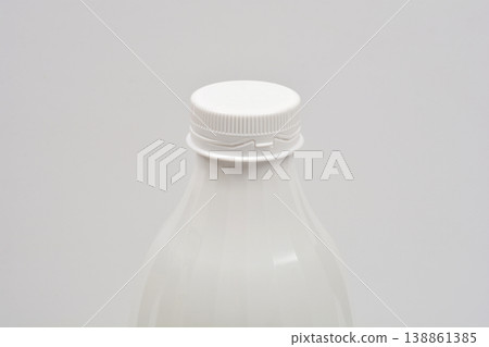 White plastic bottle with screw cap on gray background 138861385