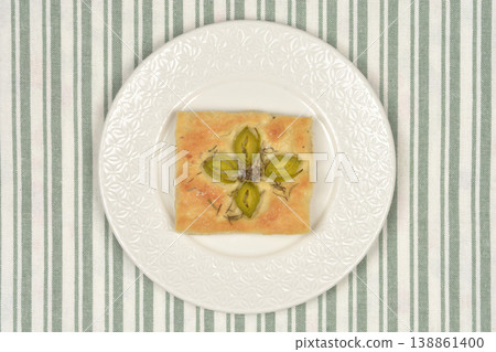 Focaccia Slice with Leek Flower and Salted Capers Focaccia Slice with Leek Flower and Salted Capers 138861400