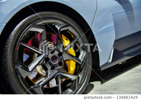 Detailed view of the carbon-ceramic braking system and multi-spoke alloy wheel on a grey sports car 138861429