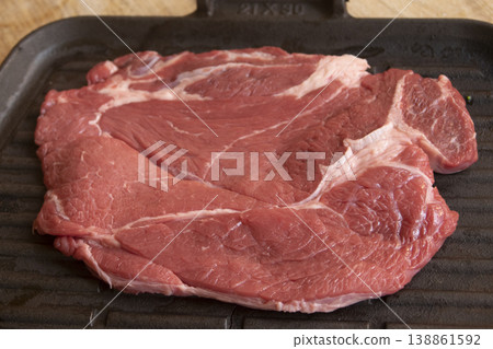 Raw beef chuck steak on cast iron griddle 138861592