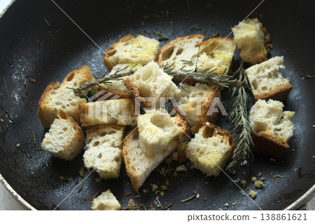 Toasted bread croutons with rosemary in a pan Toasted bread croutons with rosemary in a pan 138861621