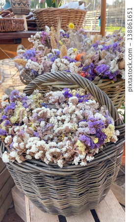 Beautiful dried Limonium sinuatum flowers in rustic wicker baskets for boho style home decoration Beautiful dried Limonium sinuatum flowers in rustic wicker baskets for boho style home decoration 138861651