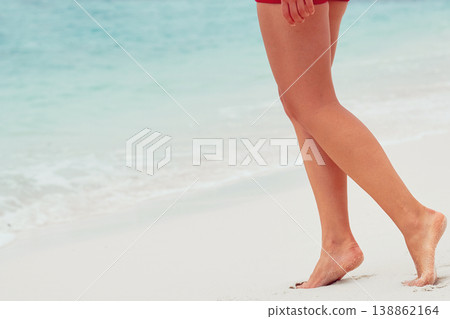 Woman legs closeup walking on white sand relaxing in beach. Sexy lean and tanned legs. Sunmmer holidays, loss weight or epilation concept. Maldives vacation travel. Skin Care. Woman legs closeup walking on white sand relaxing in beach. Sexy lean and tanned legs. Sunmmer holidays, loss weight or epilation concept. Maldives vacation travel. Skin Care. 138862164