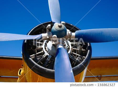 Closeup of aircraft radial engine with three blade propeller against blue sky at outdoor aviation airshow 138862327