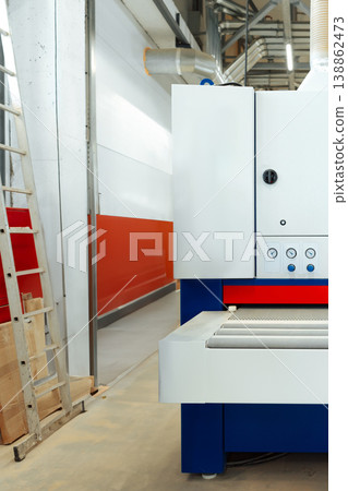 Machine in a factory setting with a ladder and a wall painted red Machine in a factory setting with a ladder and a wall painted red 138862473