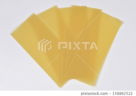 Dry Lasagna Pasta Sheets on White Background Dry Lasagna Pasta Sheets on White Background 138862522