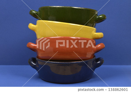 Stack of Colorful Clay Pots on Blue Background Stack of Colorful Clay Pots on Blue Background 138862601