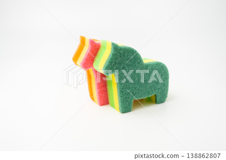 large multi-colored sponge for washing dishes in the form of a horse isolated large multi-colored sponge for washing dishes in the form of a horse isolated 138862807