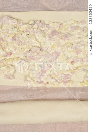Preparing puff pastry rolls with cheese cream cheese and ham Preparing puff pastry rolls with cheese cream cheese and ham 138863439