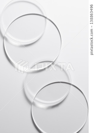 Glass circles on a white background. A template for placing samples of cosmetics or medical products or food. Glass circles on a white background. A template for placing samples of cosmetics or medical products or food. 138863496