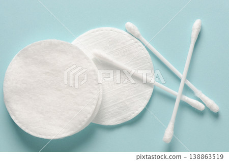 Cotton swabs and cotton pads for hygiene. Blue background. Cotton swabs and cotton pads for hygiene. Blue background. 138863519