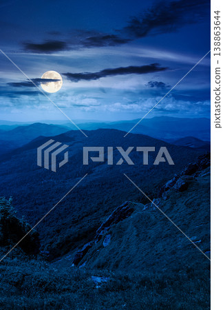 picturesque mountainous countryside scenery at night. full moon over dynamic sky above the distant valley. green meadows and rocks on the hill. mysterious nature scenery of carpathian mountains picturesque mountainous countryside scenery at night. full moon over dynamic sky above the distant valley. green meadows and rocks on the hill. mysterious nature scenery of carpathian mountains 138863644