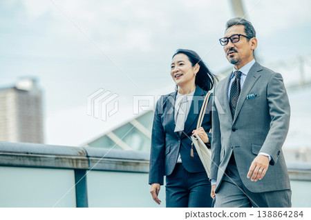 Senior businessmen (male and female) 138864284