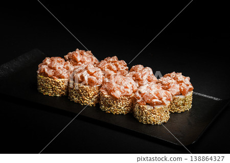 Delicious Fresh Salmon Sushi Rolls Presenting Exquisitely on a Black Background Delicious Fresh Salmon Sushi Rolls Presenting Exquisitely on a Black Background 138864327