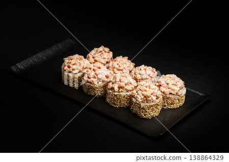 Delicious Fresh Salmon Sushi Rolls Presenting Exquisitely on a Black Background Delicious Fresh Salmon Sushi Rolls Presenting Exquisitely on a Black Background 138864329