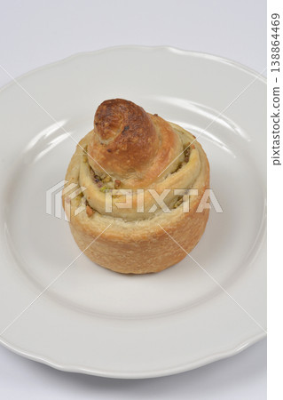 Pistachio Puff Pastry Roll on a White Plate Pistachio Puff Pastry Roll on a White Plate 138864469