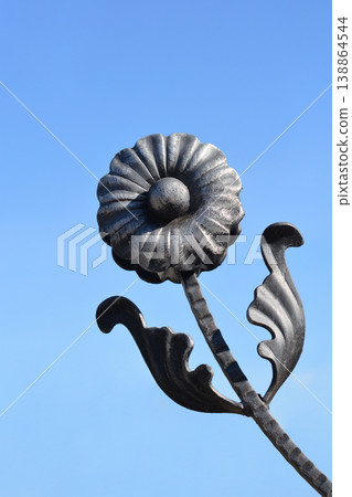 Wrought iron flower detail on a fence Wrought iron flower detail on a fence 138864544