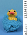 Yellow Crocheted Duckling on Blue Yarn Ball 138864583